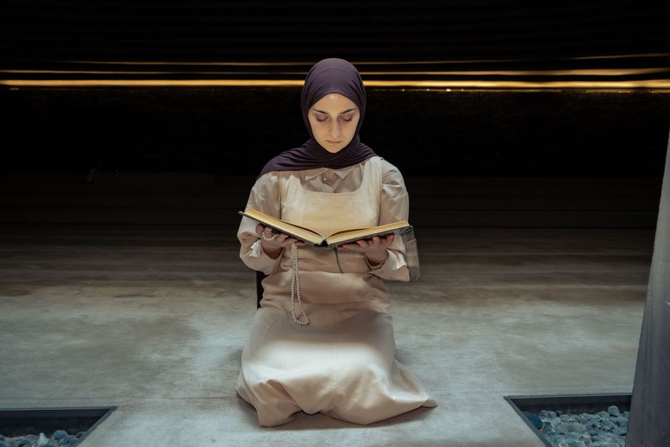 A woman studying Quran at home